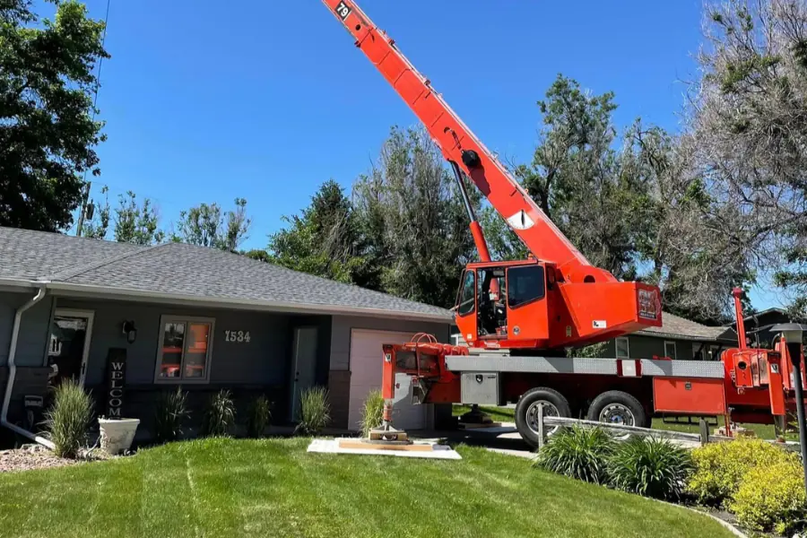 A crane parked on a driveway using ground protection mats