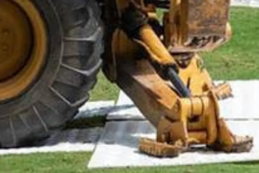 A backhoe on a Wright Environmental Ground Protection Mat